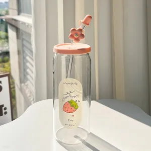 Detail of clear glass tumbler with pink flower straw cover and strawberry decal stickers