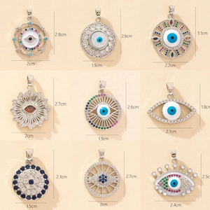 Colorful zircon evil eye pendants in nine styles with dimensions shown on beige background
