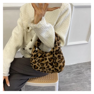 Brown leopard print plush handbag styled with a white tweed jacket for a trendy look