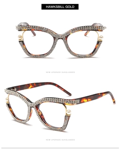 Detailed close-up of tortoise shell cat-eye frame with rhinestones and pearls inlay