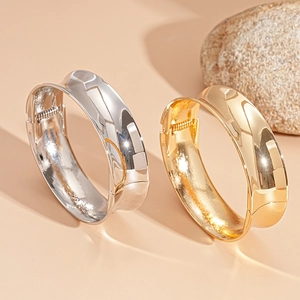 Minimalist geometric open metal bangles in polished gold and silver finish with spring clasp