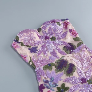 Close-up of purple floral embroidery and sparkling sequins on a strapless dress