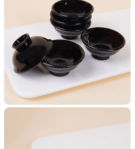 Close-up of mini Japanese black glossy sauce bowls for dollhouse kitchen miniatures