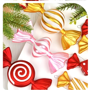 Close-up of golden and pink Christmas candy ornaments with glitter and pearl texture