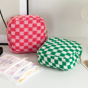 Portable checkerboard knit makeup bags with silver zippers in green and pink colors