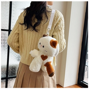 Detail of cute plush calico cat backpack with adjustable straps worn by a model