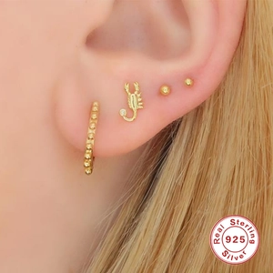 S925 sterling silver scorpion earring set with gold ball studs on model's ear
