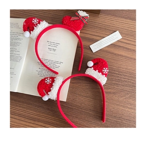 Christmas headband with red knit hat and snowflakes on a warm wooden background