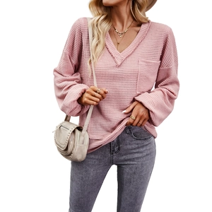 Women's pink waffle knit sweater featuring V-neck and long sleeves with chest pocket