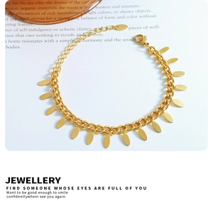 Detail of 18k gold plated stainless steel Cuban chain bracelet with leaf tassel charms