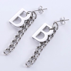 Macro shot of silver Letter B earrings featuring a chunky metal chain tassel detail
