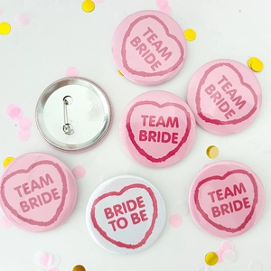Tinplate badges for bride and team bride with pink heart motifs and pin backs