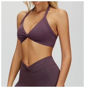 Detail of dark purple yoga set featuring a halter bra with ruched front and V-waist leggings