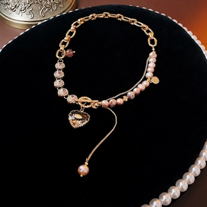 Luxury heart pendant necklace with lavender pearls and shimmering rhinestone fringe