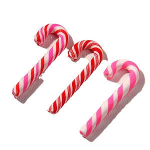 Three polymer clay candy cane charms with colorful spiral stripes on white background