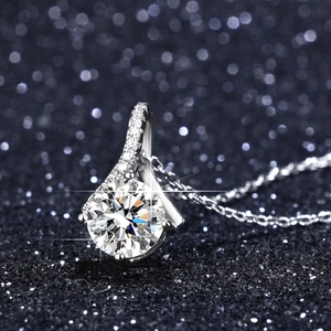 Macro shot of a one-carat round moissanite pendant with sparkling six-prong setting