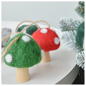 Close-up of wool felt Christmas mushroom ornaments with white dots and rustic wooden bases