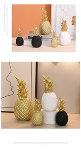 Detail showing resin pineapple decor with diamond textures and golden leaves for home shelf