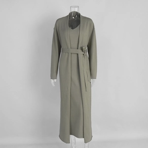Detail of knitted long cardigan and slim dress set with waist belt in olive green