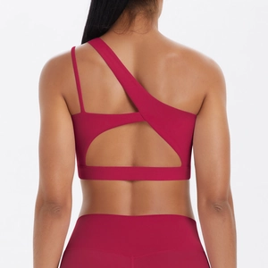 Detail of one-shoulder magenta sports bra with cutout back and high-waisted leggings