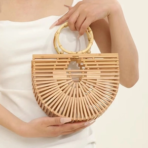 Detailed macro view of handcrafted semi-circular bamboo handbag with hollow woven texture