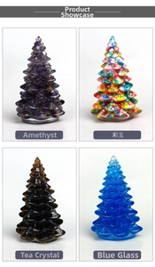 Detail view of four crystal Christmas tree ornaments in amethyst, quartz and colored glass