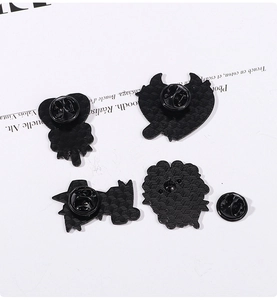 Detail view of four black metal enamel pin backs with butterfly clutch and textured finish