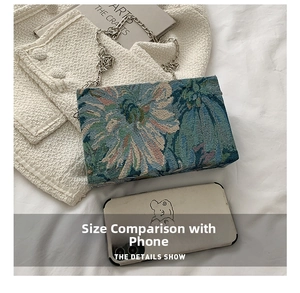 Floral jacquard chain bag size comparison with a smartphone on a white background