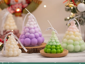 Detail of bubble Christmas tree candles with ribbons in festive holiday setting