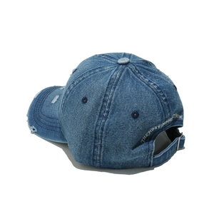 Detailed back view of distressed denim baseball cap with embroidery and adjustable buckle