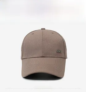 Detailed front view of brown breathable baseball cap with textured stripes and metal sports logo