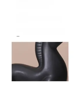 Close-up of modern minimalist black horse statue showing matte finish and sleek curves