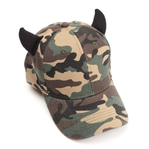Detailed close-up of a camouflage baseball cap featuring unique black devil horns on top