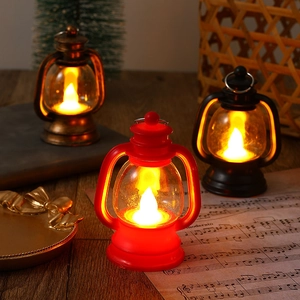 Three vintage LED Christmas lanterns in bronze, red, and black on a wooden table setup