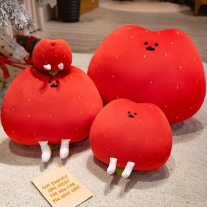 Cute strawberry plush toy set in three sizes on a cozy beige rug with festive decor