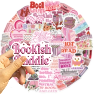 Close-up of a hand holding a Bookish Baddie pink waterproof sticker for DIY decoration