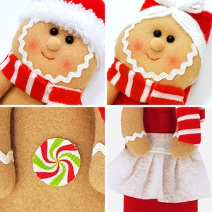 Detailed macro view of handmade gingerbread man felt dolls with festive red and white scarves