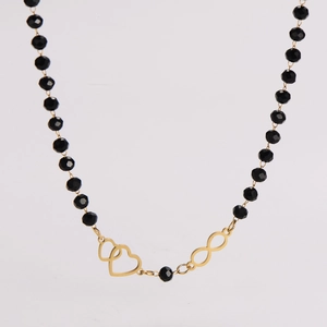 Detail of beaded necklace featuring gold infinity symbol and interlocking hearts charms