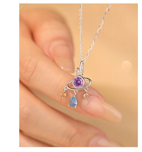 Macro shot of S925 sterling silver planet necklace with colorful zircon gemstones
