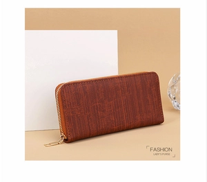 Detail of vintage textured brown long wallet with golden zipper for women