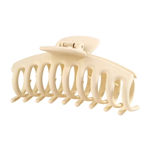 Close-up of a matte cream-colored shark hair claw clip with a strong spring design