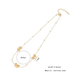 Detail of gold bow necklace with 40+5cm length and stainless steel material specs