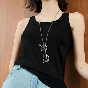 Chic silver metal eye glasses pendant necklace styled on a model for a creative look
