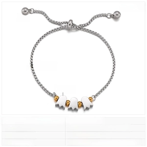 Detail of adjustable stainless steel bracelet with golden heart charms and specs
