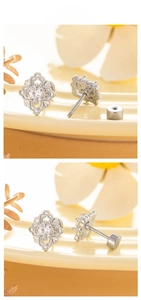 Macro view of vintage silver floral stud earrings with zircon and flat screw backs
