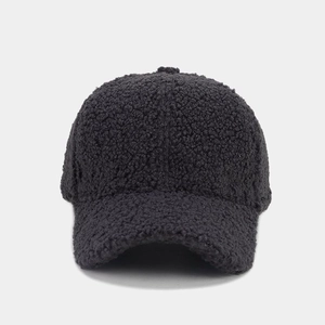 Close-up of the thick black faux lamb wool texture on the winter baseball cap surface