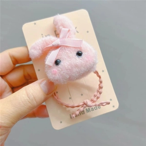 Handmade pink plush bunny hair tie with bow on display card for girls and toddlers