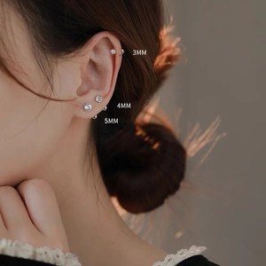 Detailed view of 3mm, 4mm, and 5mm zircon screw back stud earrings on ear cartilage