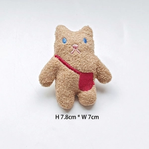 Detail of plush bear patch with blue embroidery and red bag, size H7.8cm x W7cm