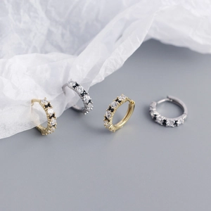 Close-up of gold and silver S925 sterling silver hoop earrings with clear and black zircon
